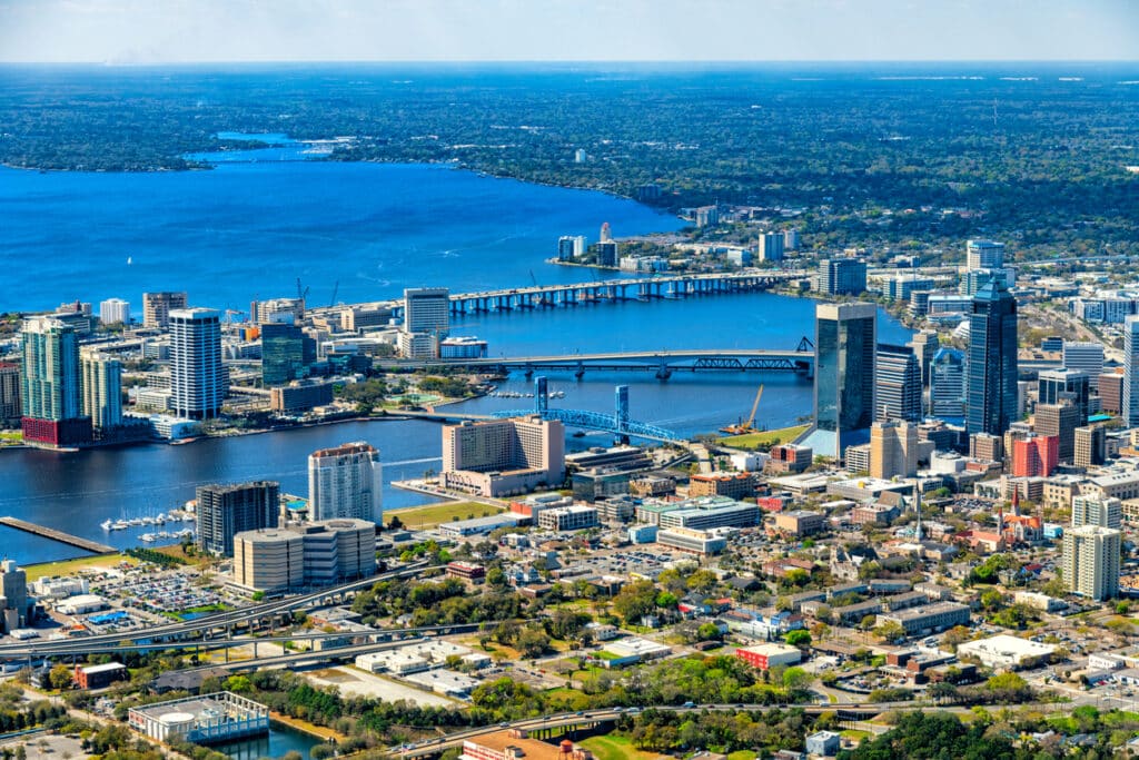 The urban skyline of Jacksonville, Florida with the St. John's River dividing the city shot from an altitude of about 1000 feet over the city.