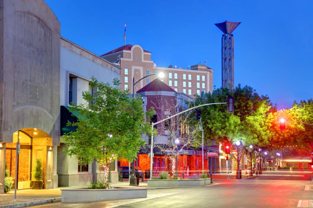 Modest, CA view of street lights and buildings at dusk