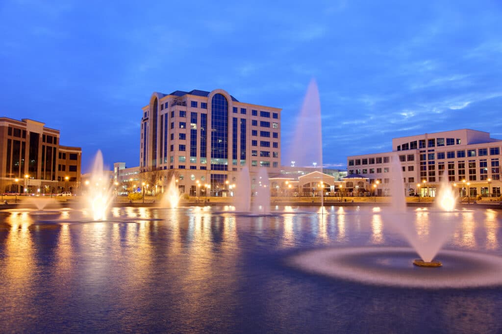 Newport News, VA view of buildings fronm spouting fountain at dusk
