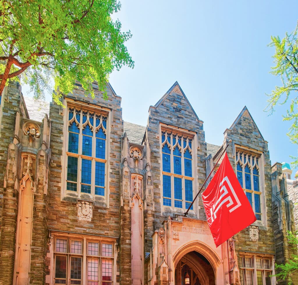 Temple University building Philadelphia with red flag and historic buildings