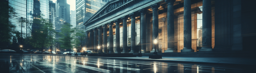 the exterior of a traditionally styled bank in a busy city, darkly lit